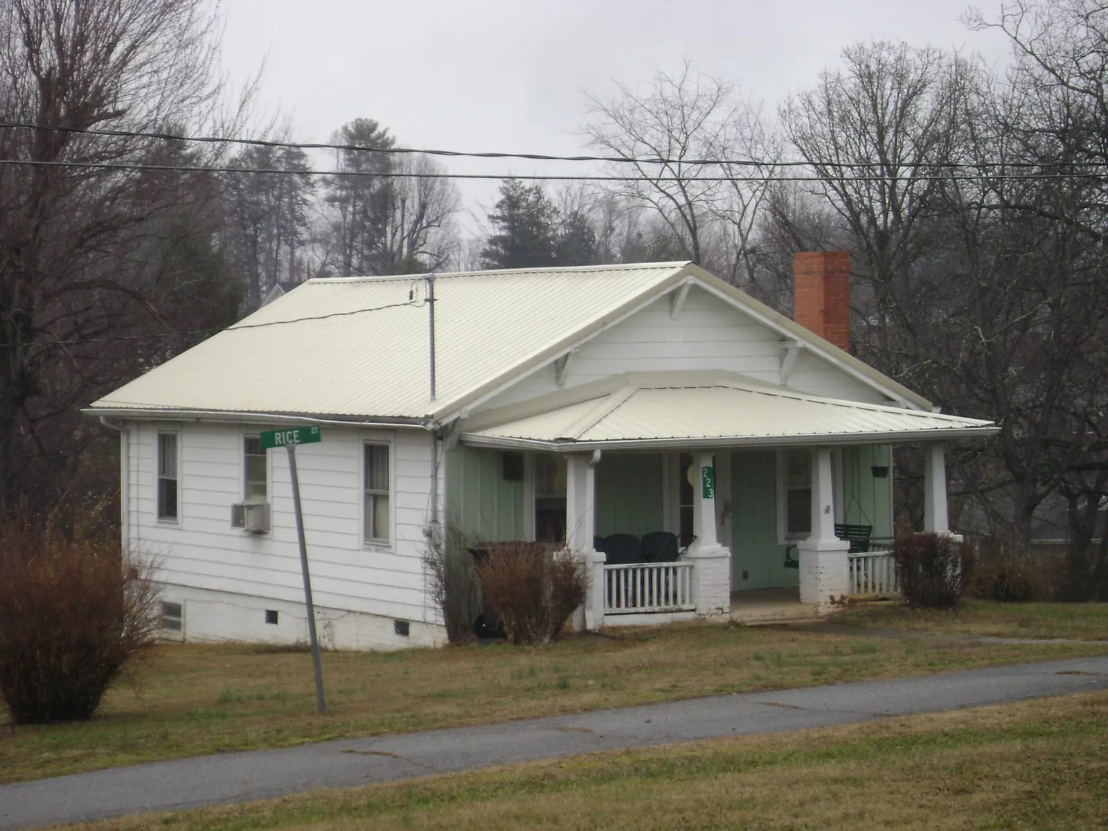 White metal roof on a craftsman bungalow at a street corner in Chesapeake City